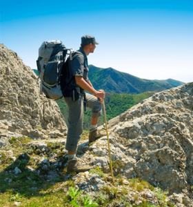 man hiking mountain after recovering from facet joint syndrome
