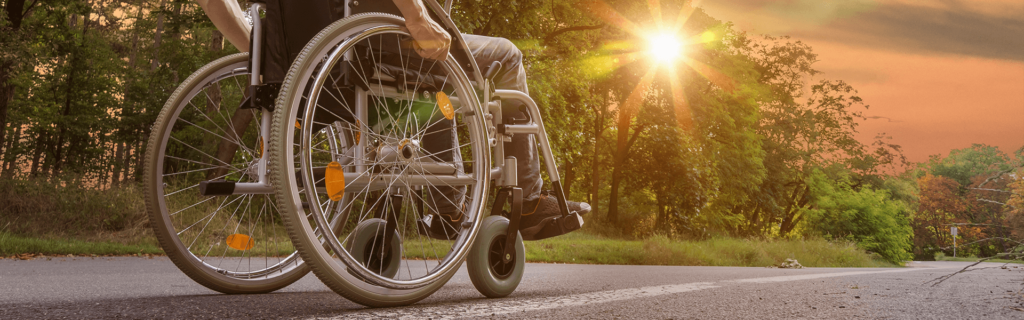 man in wheelchair with sunset