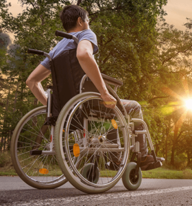 man in wheelchair with sunset