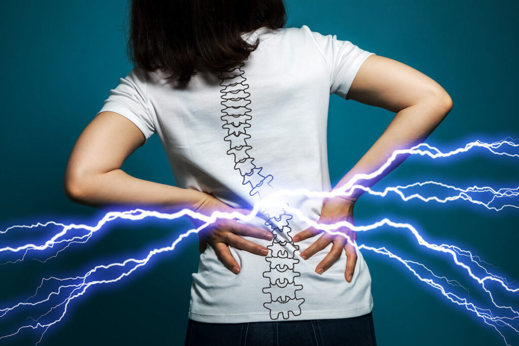 person holding lower back pain with animation of curved spine and lightning striking the pain point